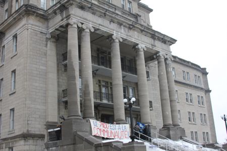 Coalition members rally in front of the Centre 7400 on March 16 for a press conference (Daryl Hubert photo).