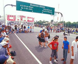 Unemployed workers blockade a highway near Buenos Aires. Similar groups have moved from working for basic survival to building libraries, bakeries, democracy and collectively run factories. photo: Indymedia Argentina