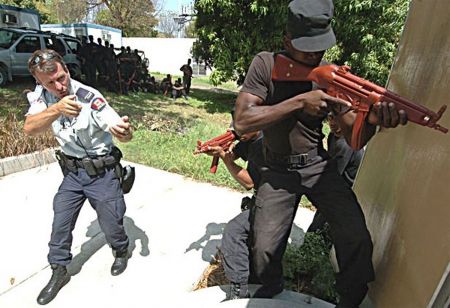 An RCMP officer trains a member of the Haitian National Police. Under the RCMP's watch, the HNP would kill thousands. During the same period, Coderre lauded the RCMP's efforts.