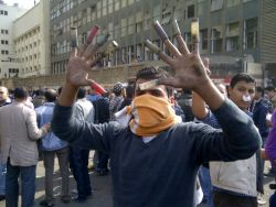 Tahrir Square protester with bullet casings on his fingers from ammunition shot at protesters by security forces and military police.