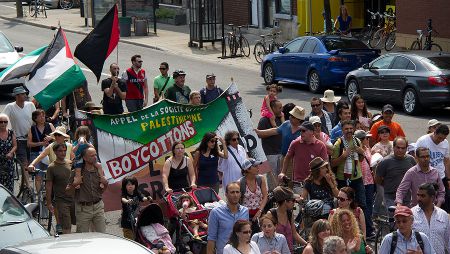 Protesters holding a banner demanding the boycott of Israel - July 19 