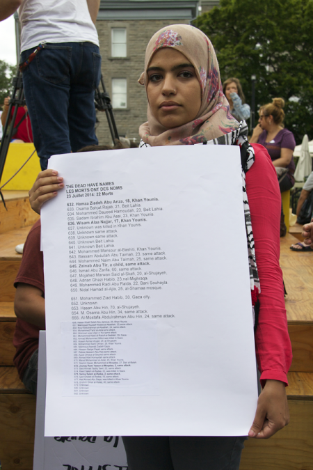 Protester holding a list of some of the names of the Palestinians killed in this latest Israeli assault on Gaza  - July 23